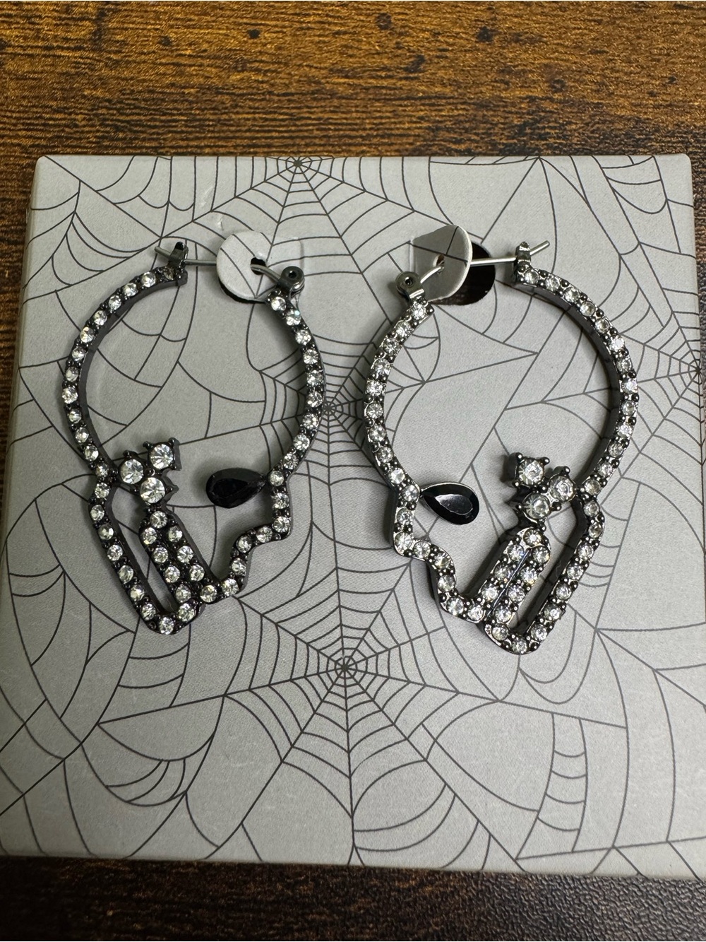 4/$20 Rhinestone Skull Hoop Earrings - Silver Crystal Accent